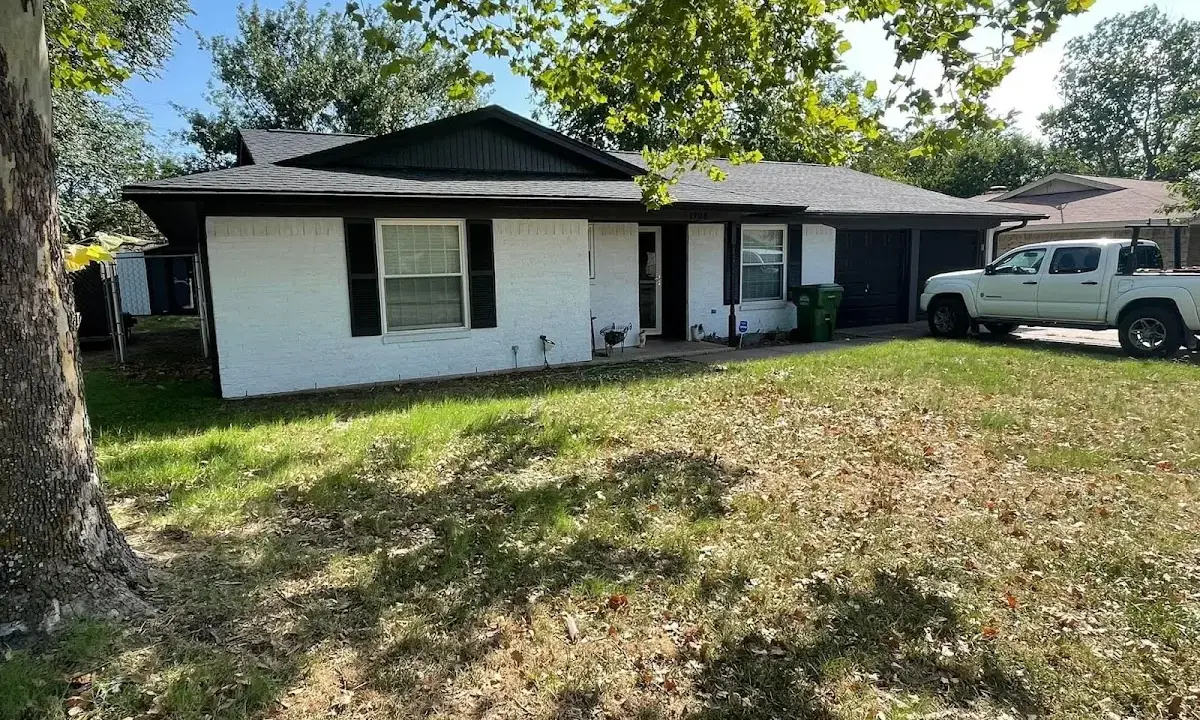 Professional roofing crew working on a residential roof in St. Ann